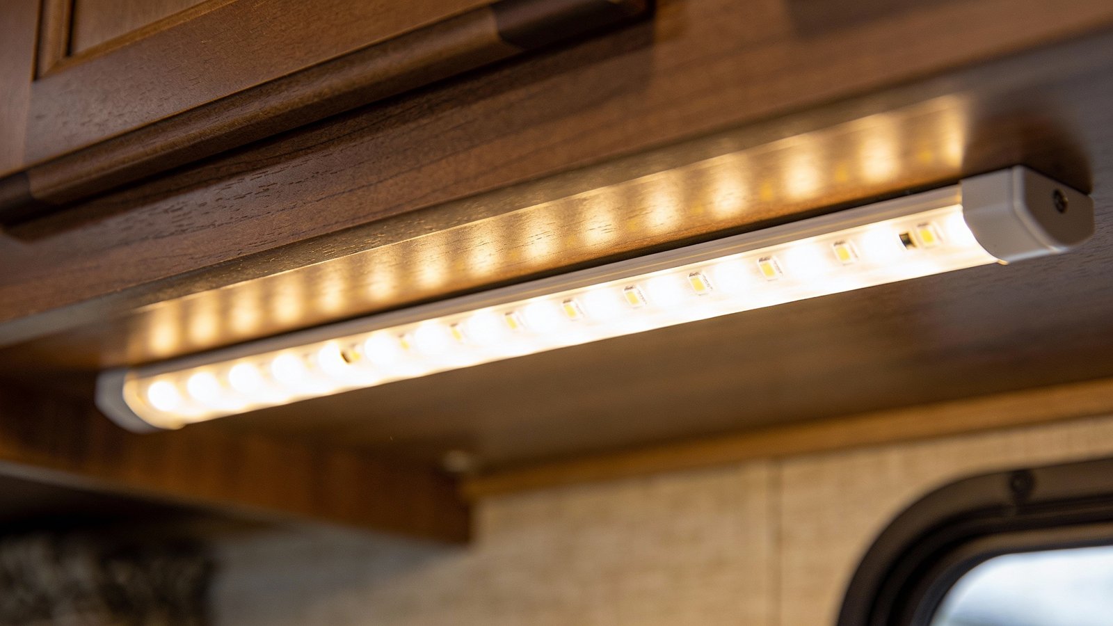 **Closeup of warm white 12V LED strip under RV cabinets**