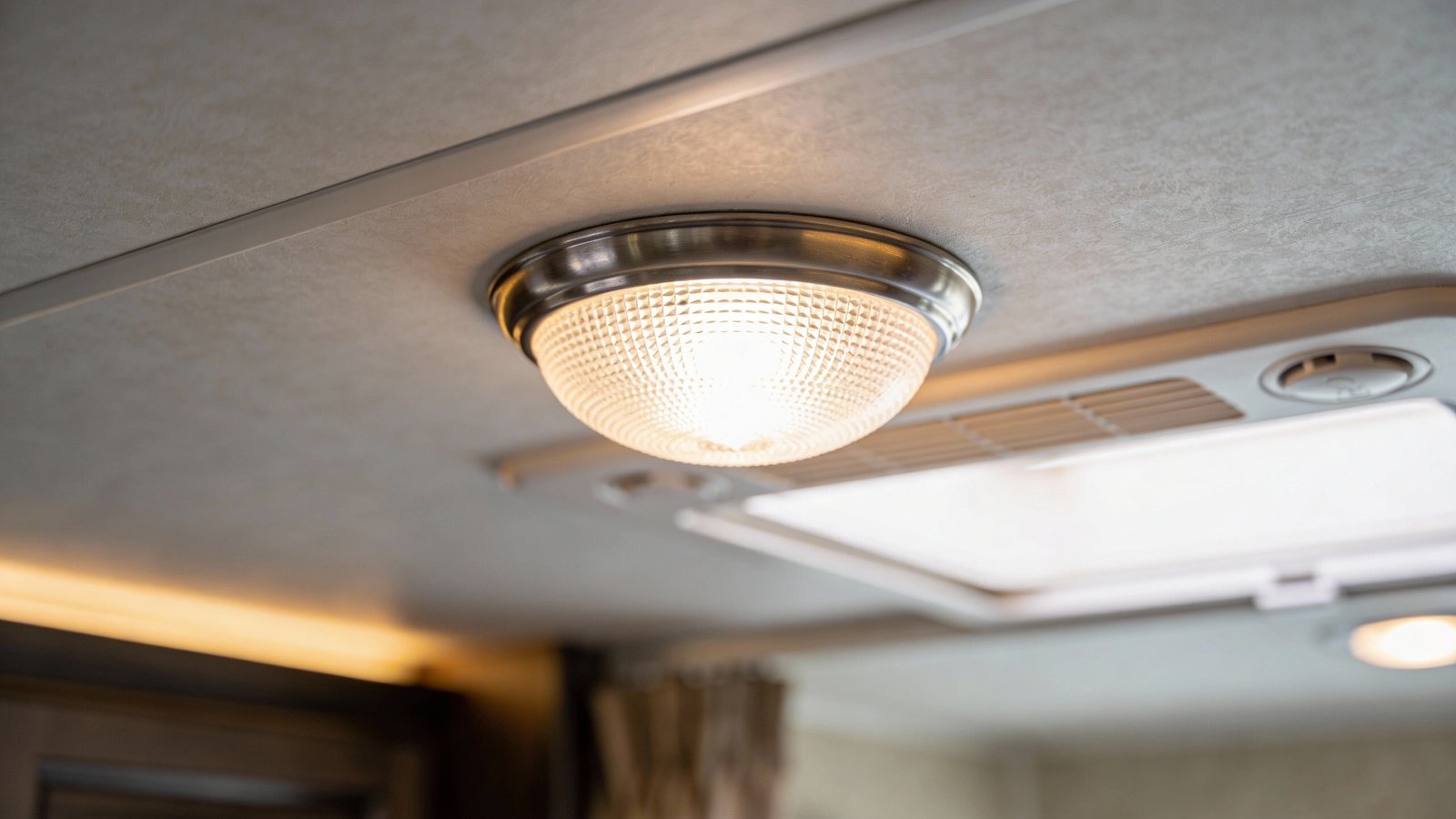 **Single dimmable 12V LED dome light glowing in RV ceiling**